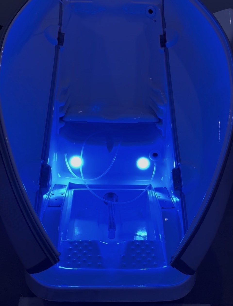 The open HOCATT chamber at SOZO, its seat and footwell glowing with blue photon light
